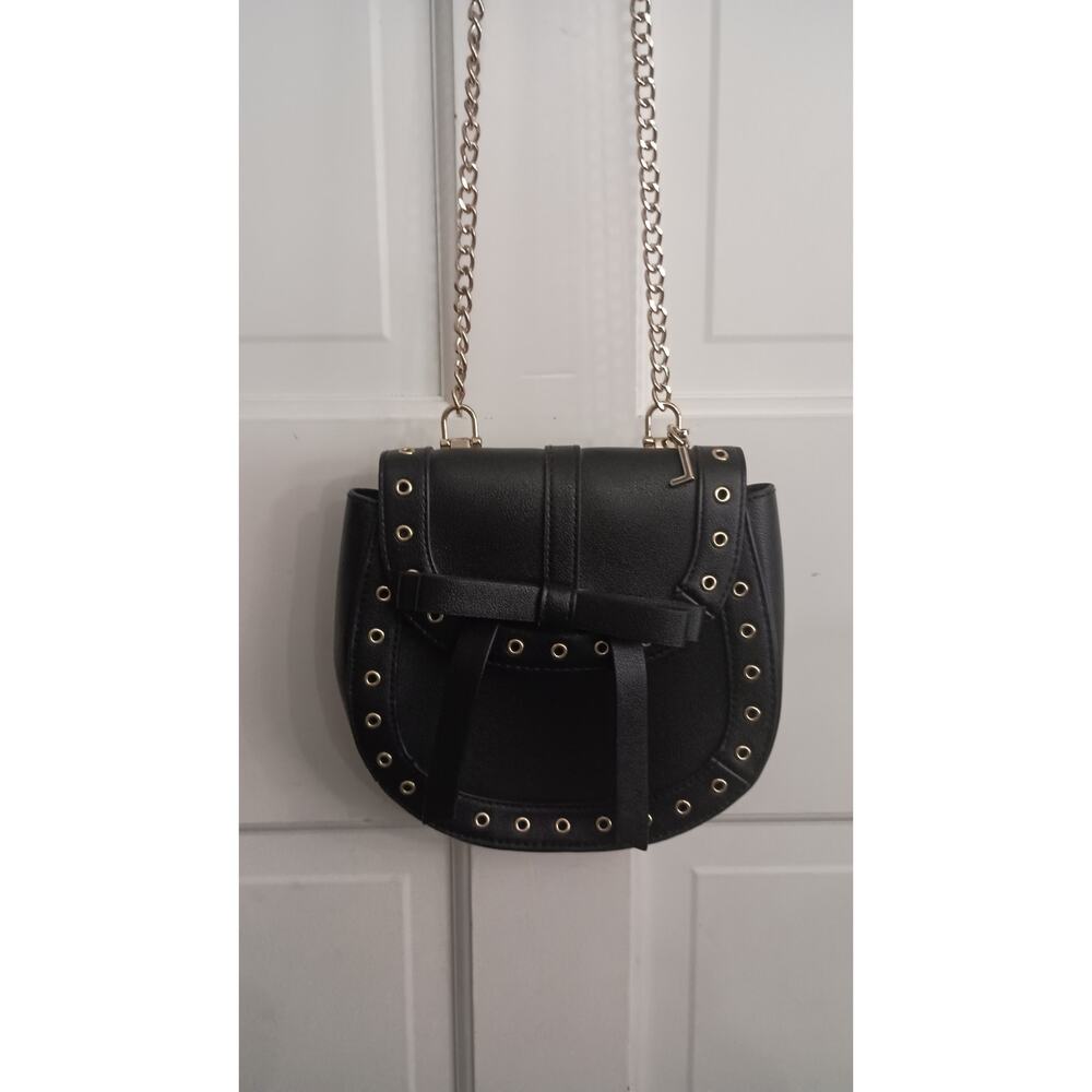 The Express Black Crossbody embellished with Bow metal grommets flap  closure. - Picture 12 of 12